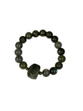 Grey beaded bracelet with a geometric stone on a white background