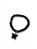 Black beaded bracelet with a star-shaped charm on a white background